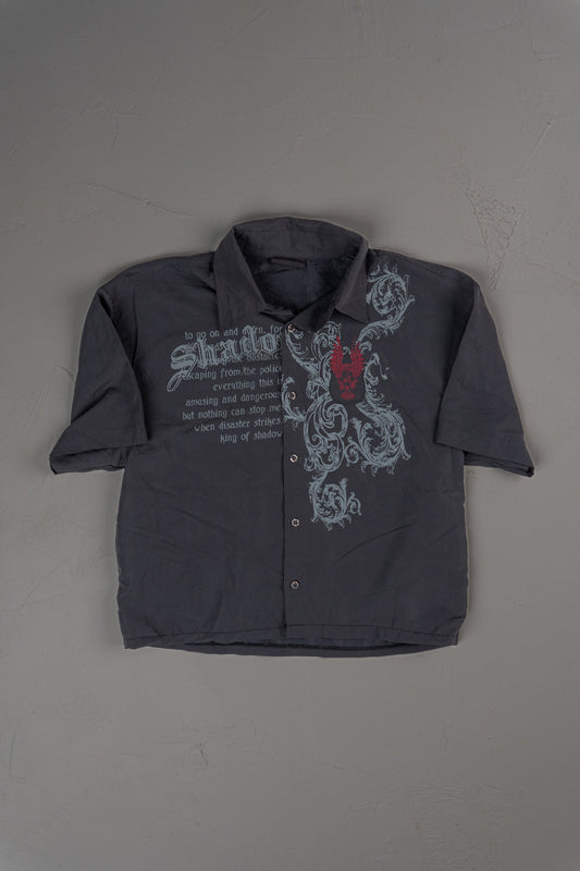 Vintage Early 2000s Y2K era graphic button-up shirt with gothic-inspired print and embroidery detail, likely Takaya. Takaya Cropped Button-up T-shirt